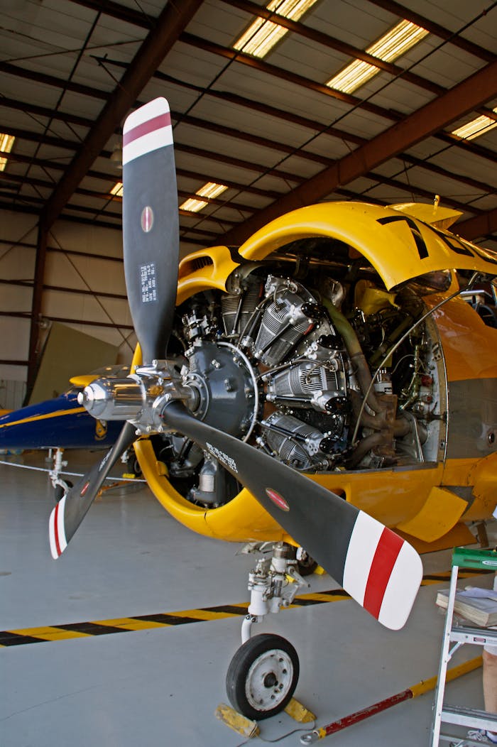 Services A vintage aircraft with an exposed radial engine inside a hangar in Titusville, Florida.