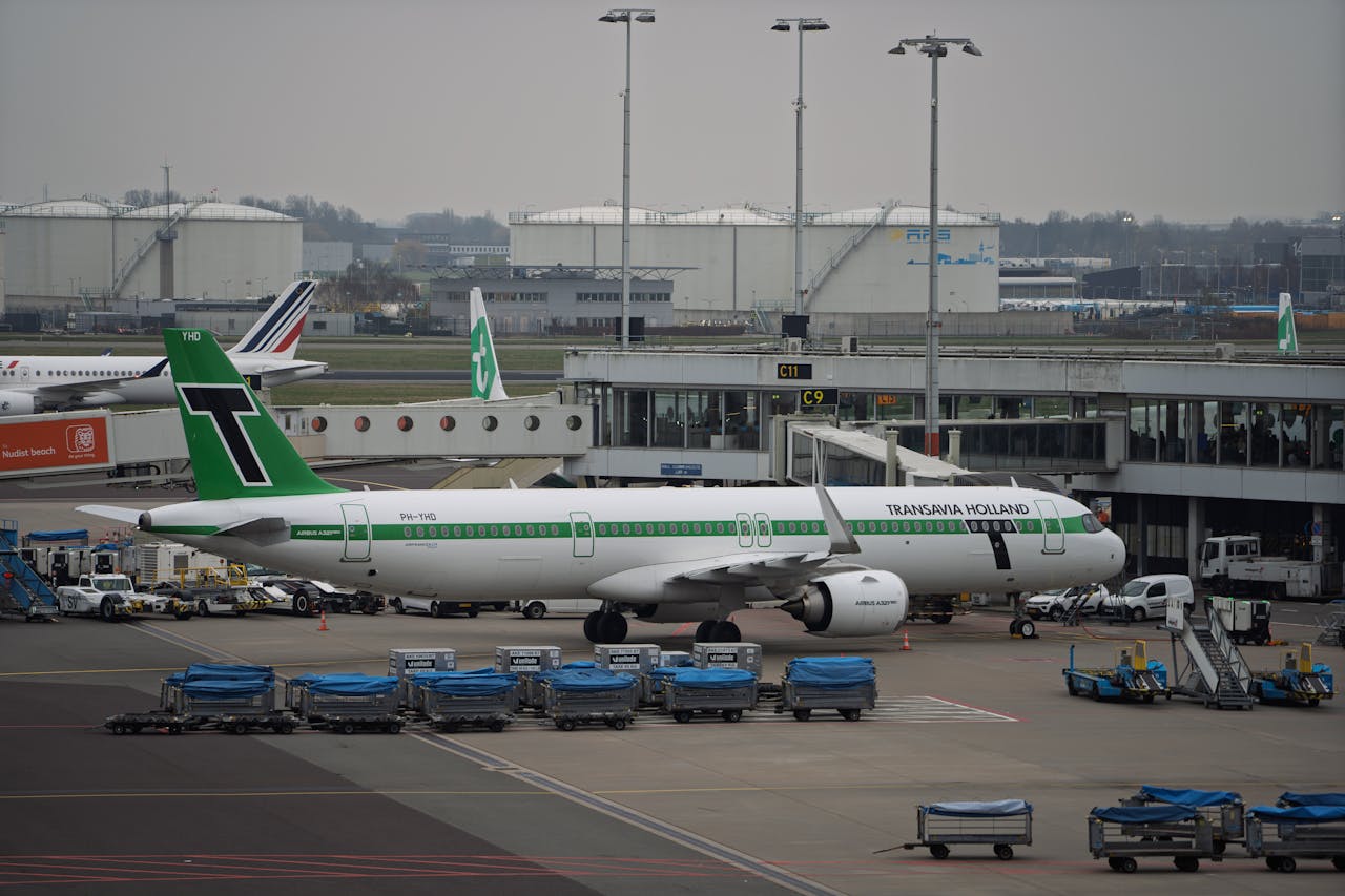 About Transavia Holland airplane parked at the airport gate, ready for boarding.